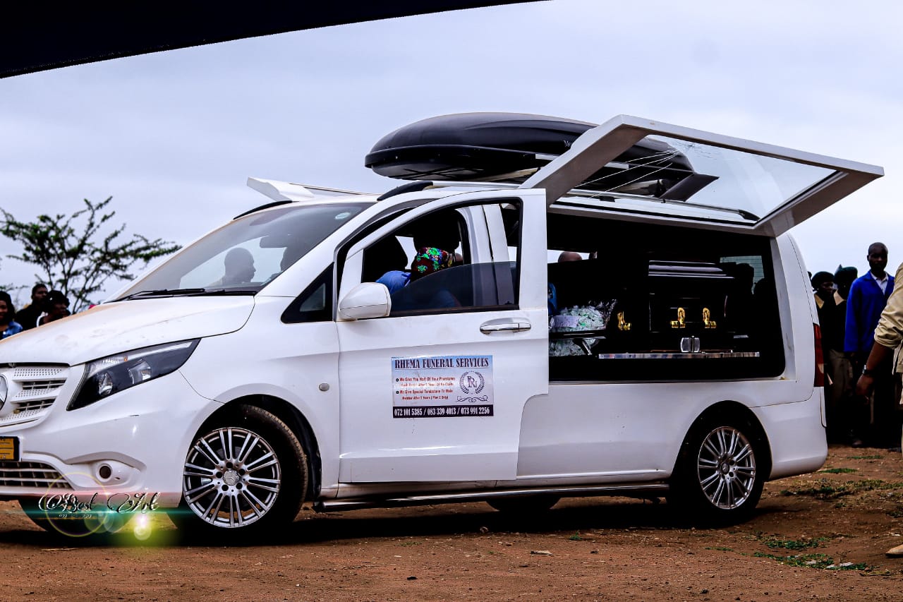 White hearse with open side door during service